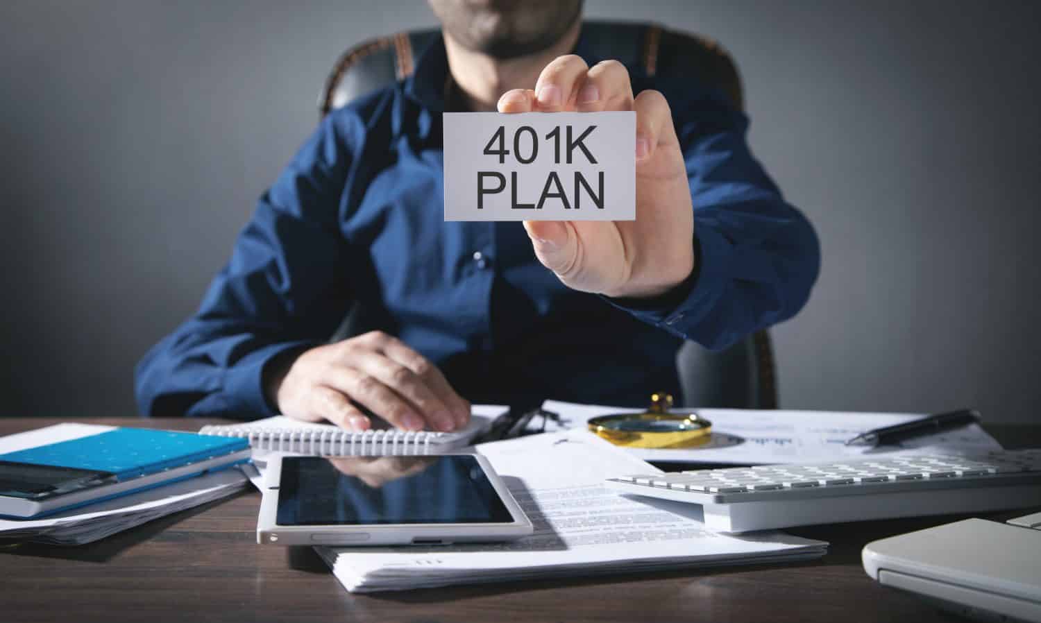 Businessman showing 401K Plan on business card. Business