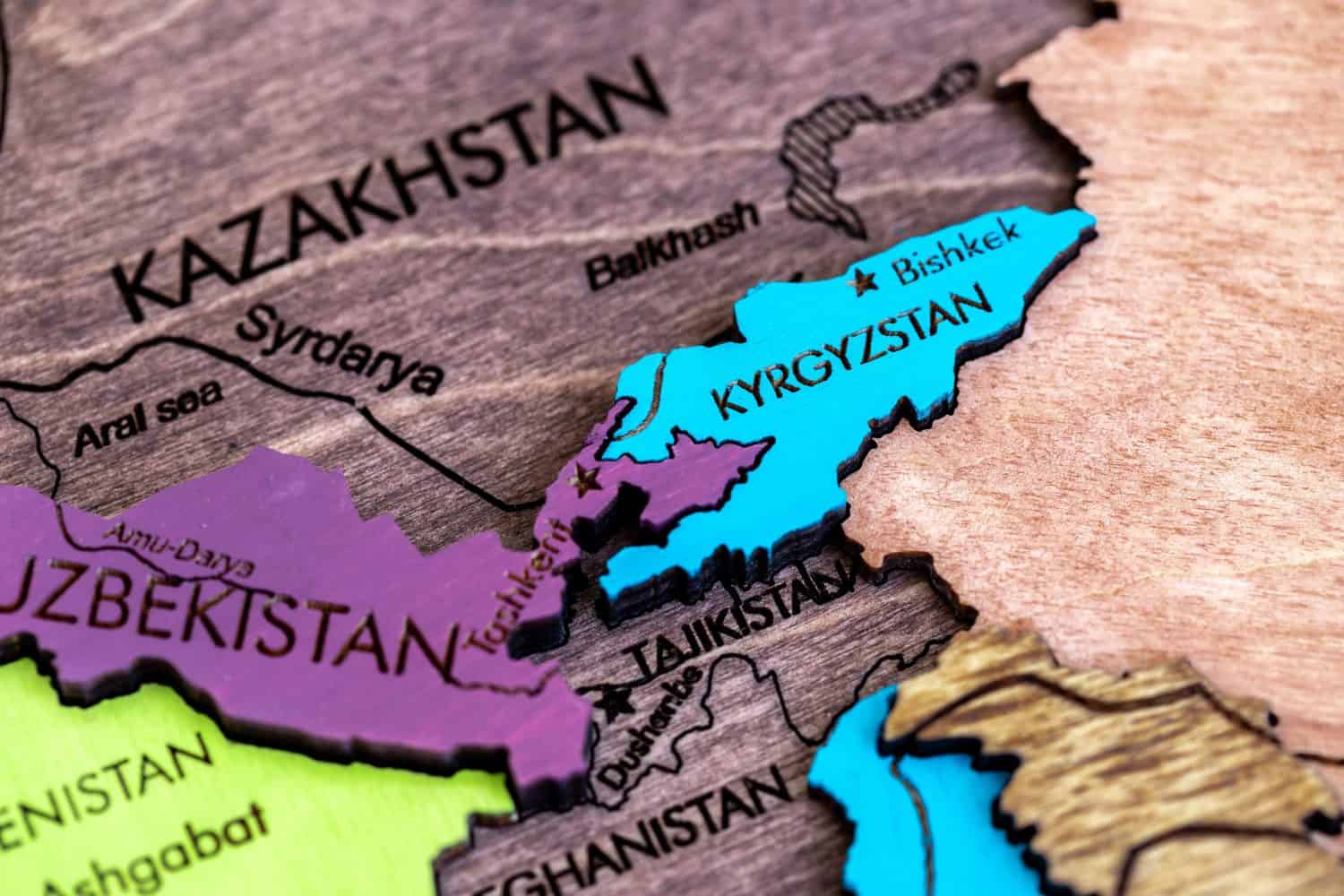 the country of Kyrgyzstan on the world map, wooden volumetric world map on a white background macro, close-up, shallow depth of field