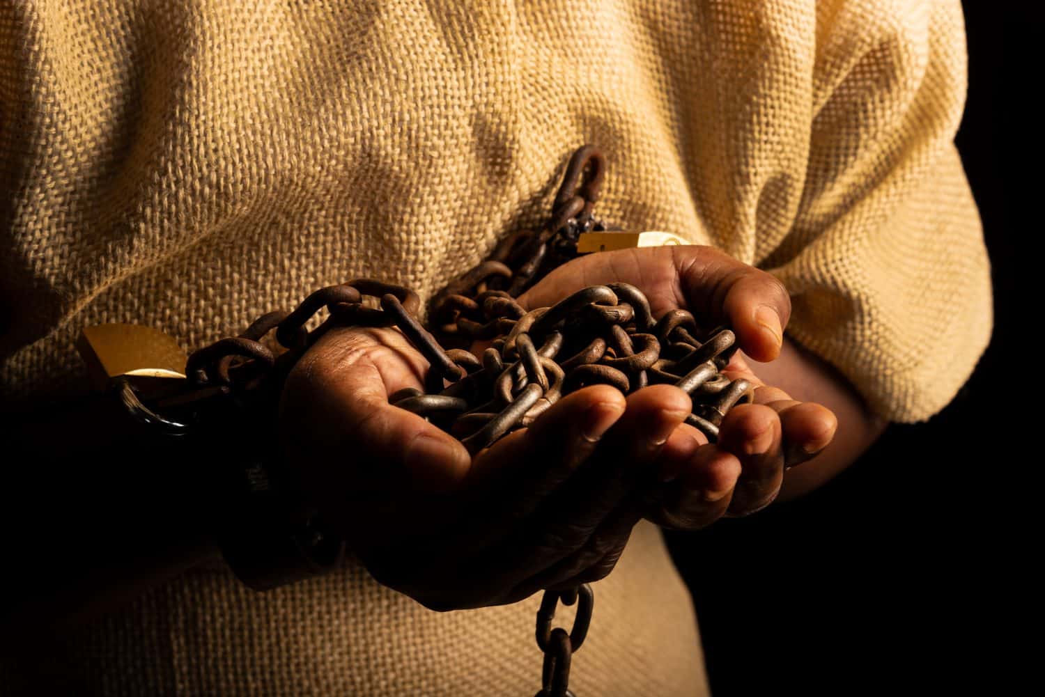 Portrait of a black woman in chains and with an iron mask on her face holding chains. Slave Anastacia. Slavery in Brazil.