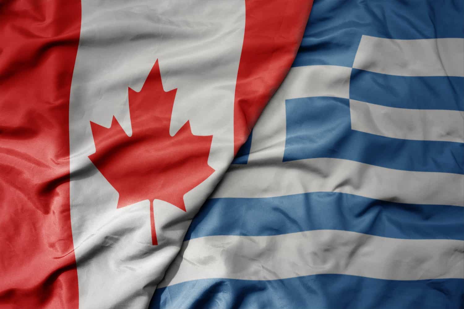 big waving realistic national colorful flag of canada and national flag of greece . macro