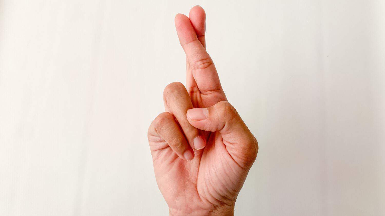 Woman hand making cross fingers, hand gesture.