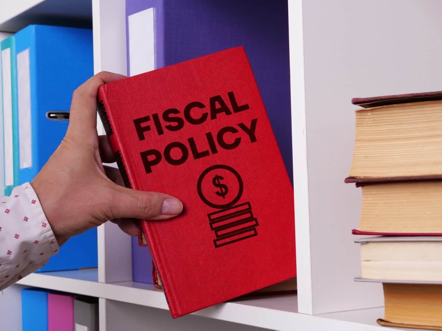 Fiscal policy written on the book. The financial data visible in the background