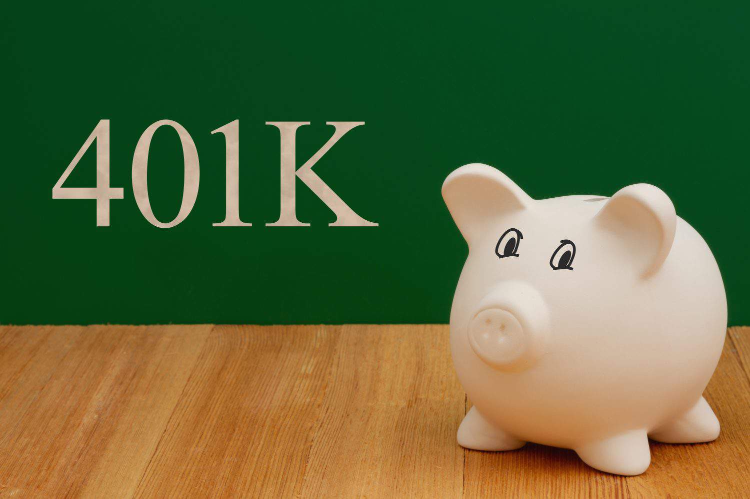 Saving money for retirement 401k with a piggy bank on a desk and chalkboard