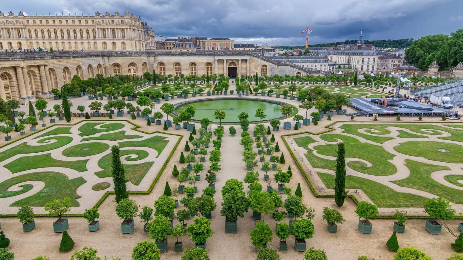 Famous palace Versailles with beautiful gardens and fountains aerial timelapse from top. The Palace Versailles was a royal chateau. Paris, France.