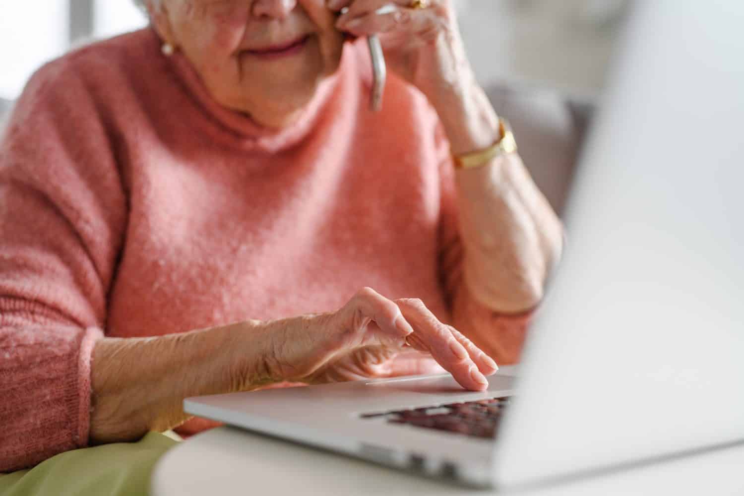 Online and phone scams targeting seniors. Scammer sending email to elderly woman, asking for money, demanding personal, sensitive informations without verification.