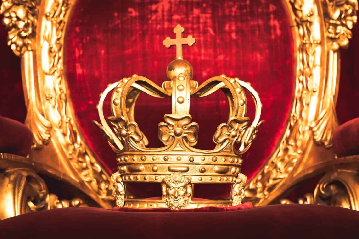 Ancient crown on red velvet. Antique symbol of authority, luxury, monarchy, nobility, success