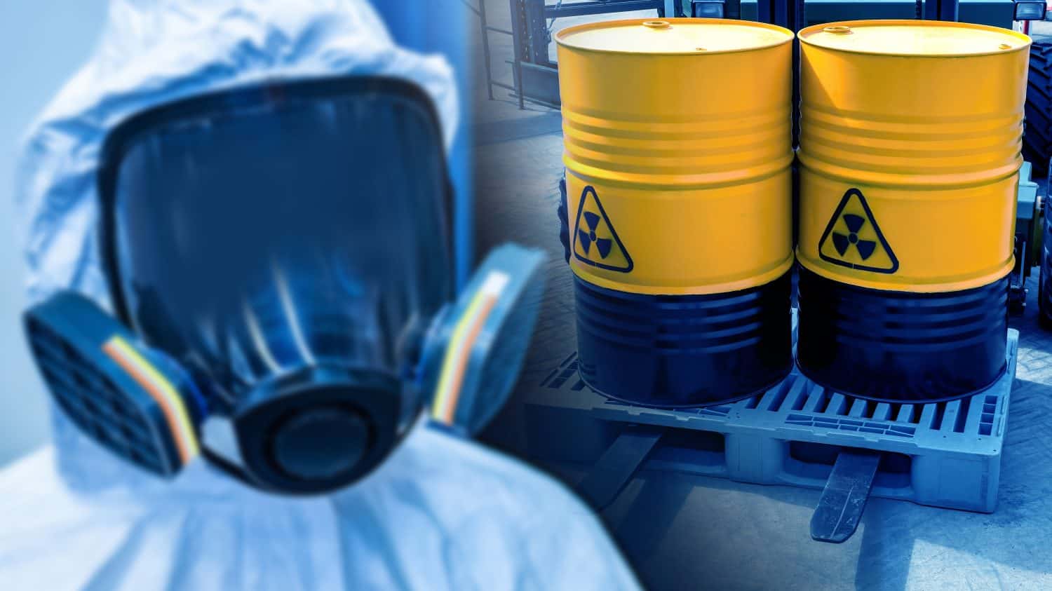 Radioactive safety. Man in radiation protection suit. Nuclear leak danger symbol on barrels. Containers with radioactive fuel on forklift. Barrels with uranium. Radioactive waste. Person in gas mask