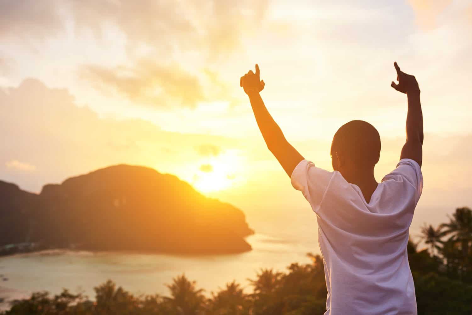 Sunset, nature and back of man with freedom for worship, religion or praise on missionary trip. Travel, ocean and Christian volunteer with spiritual awakening by evening sky for discovery in Mexico.