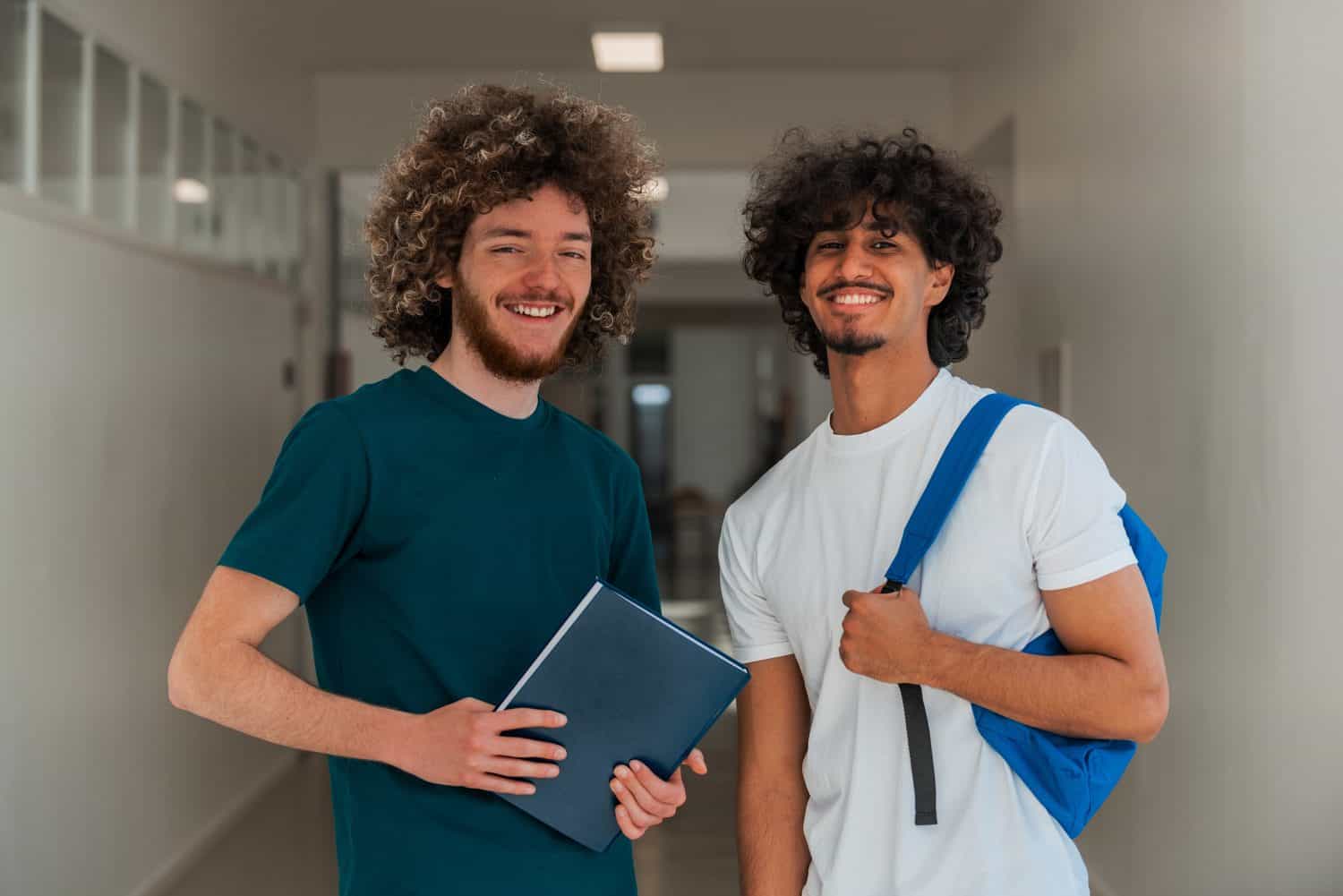 Portrait a two happy male college students on a university campus.