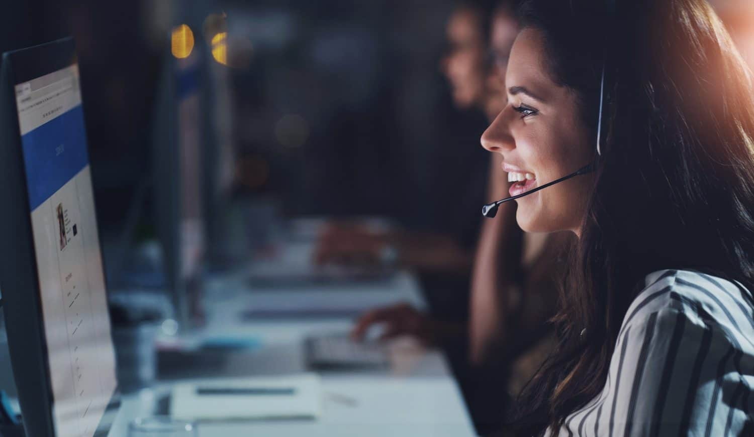 Business woman, computer and conversation in call center for telecom, help and online advice in office. Customer service agent, pc and multilingual support with translation, web chat and working late