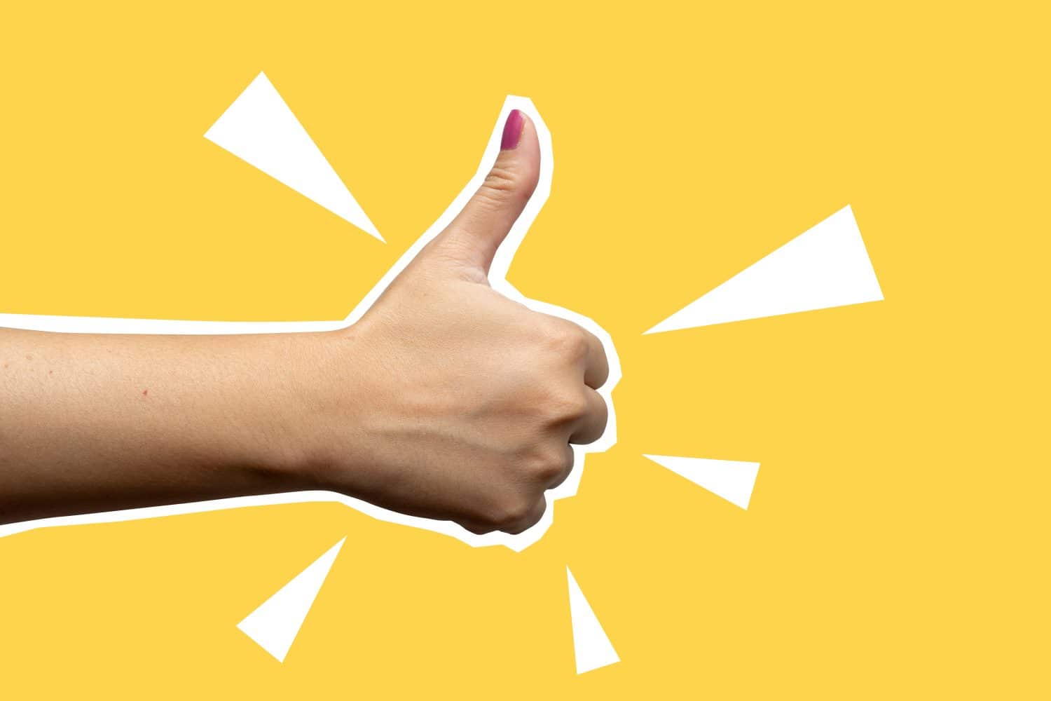 A hand giving a thumbs up on a yellow background. The thumbs up is a symbol of business, approval or agreement. Collage art