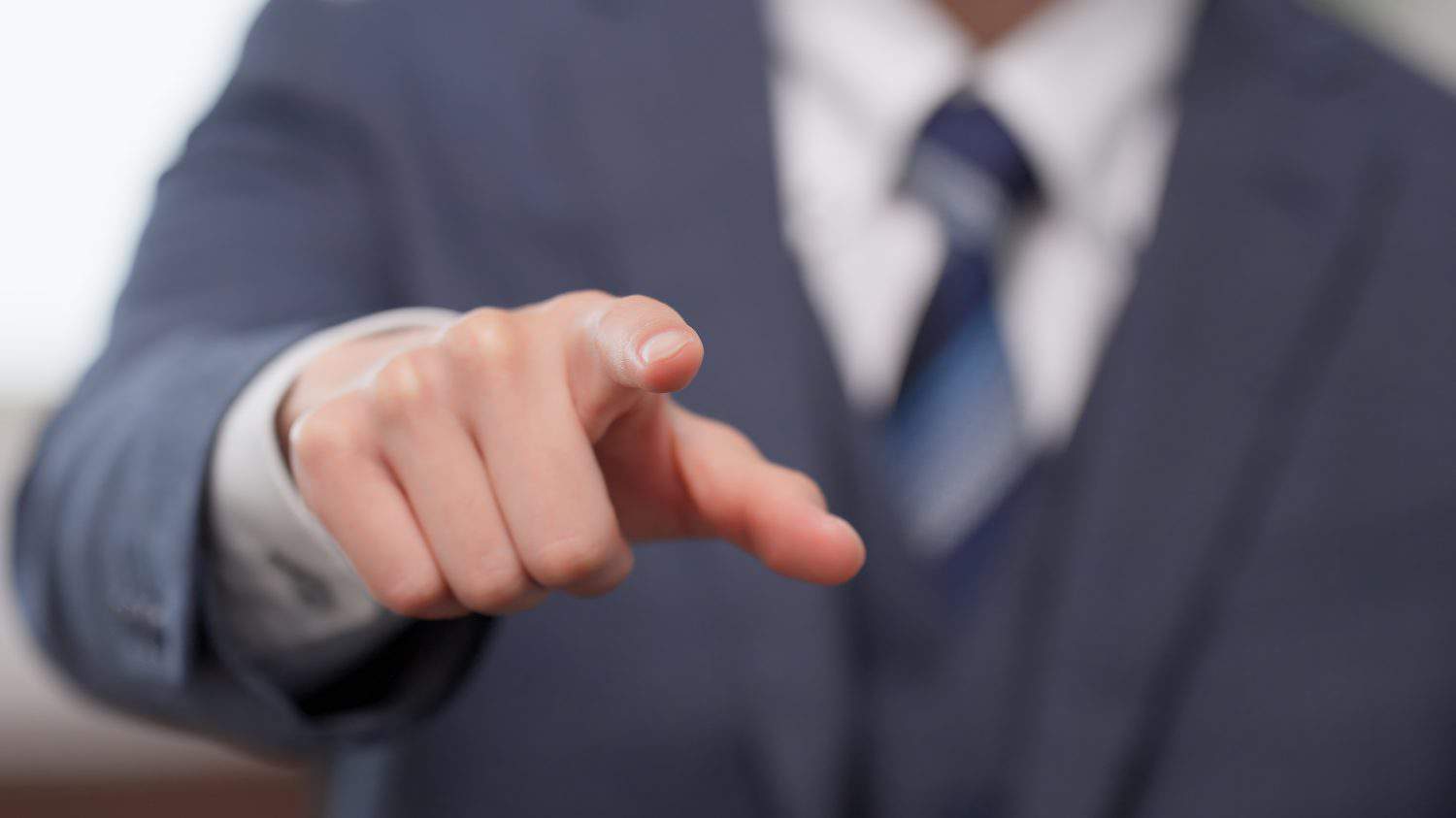 The hand of a businessman pointing