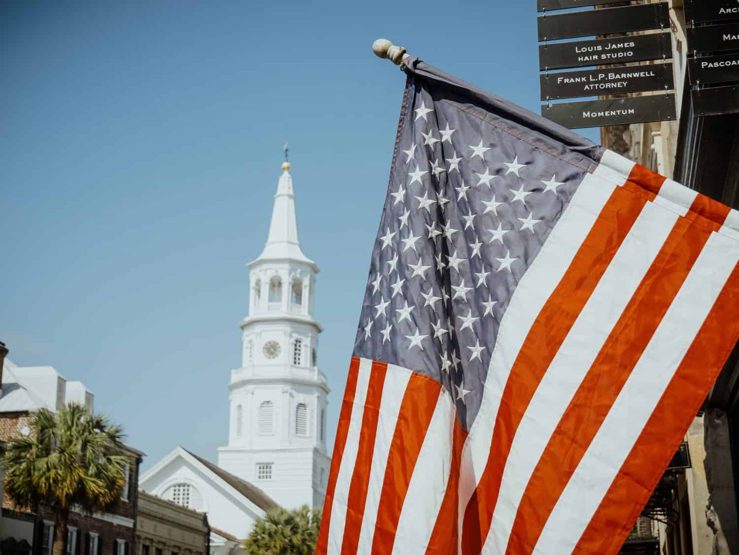 St. Michaels Church with American flag in Historical downtown area of Charleston, South Carolina