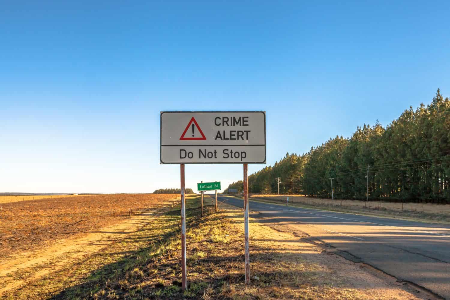 Road sign of an insecure area, without any kind of protection and high crime. Lothair on the border with Swaziland and Mozambique, South Africa.