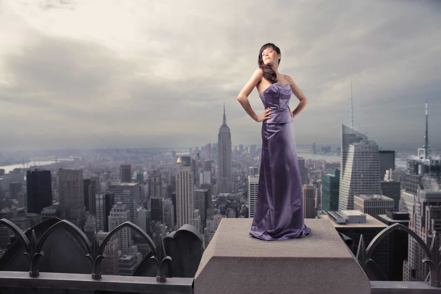 Beautiful woman standing on the rooftop of a skyscraper