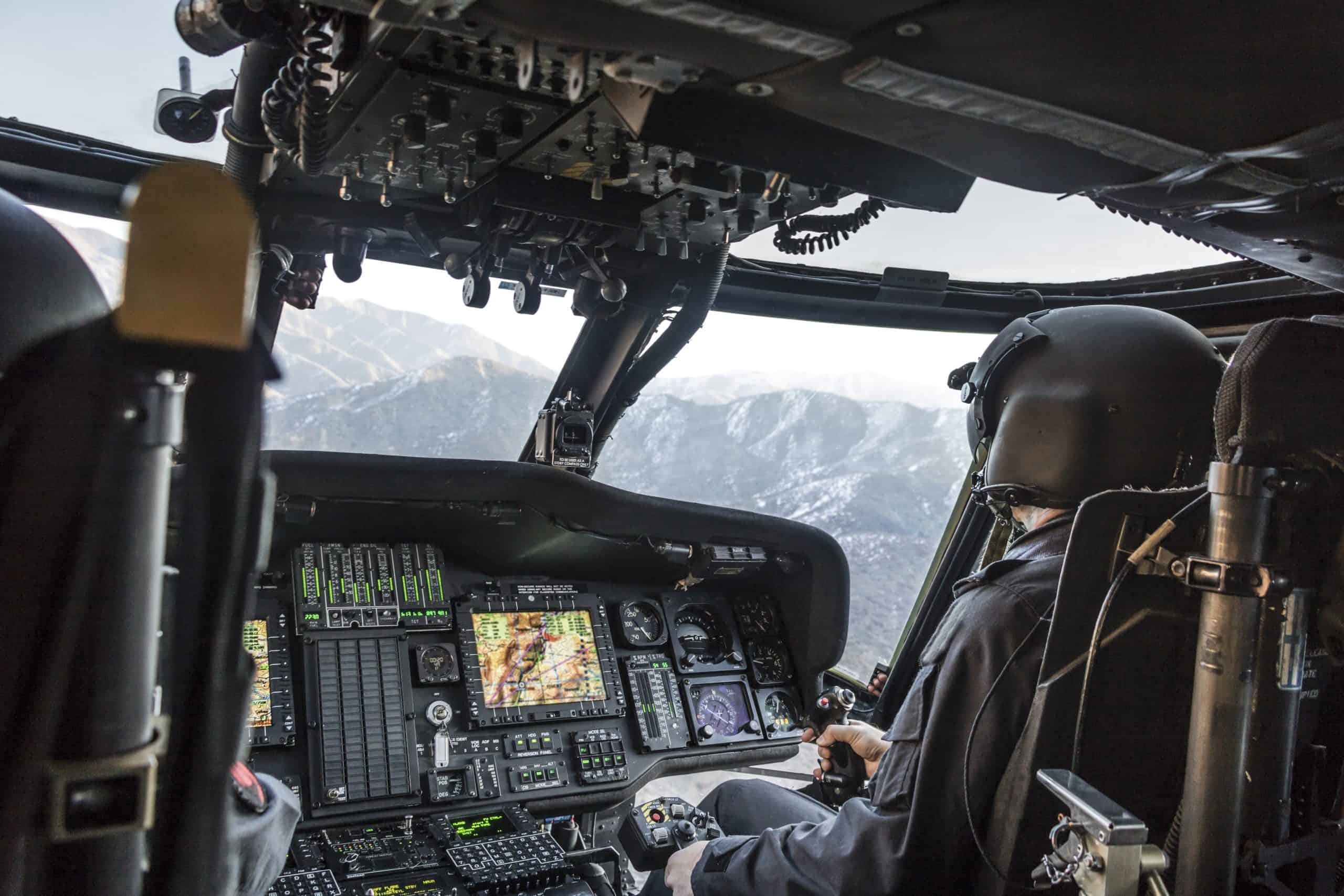 Army pilot riding military helicopter