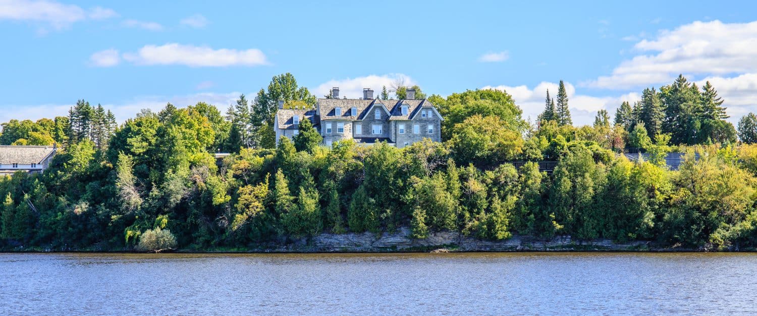 24 Sussex Drive, the official residence of the Prime Minister of Canada, sits on a forest covered hill overlooking the Ottawa River in scenic Ottawa, Canada.