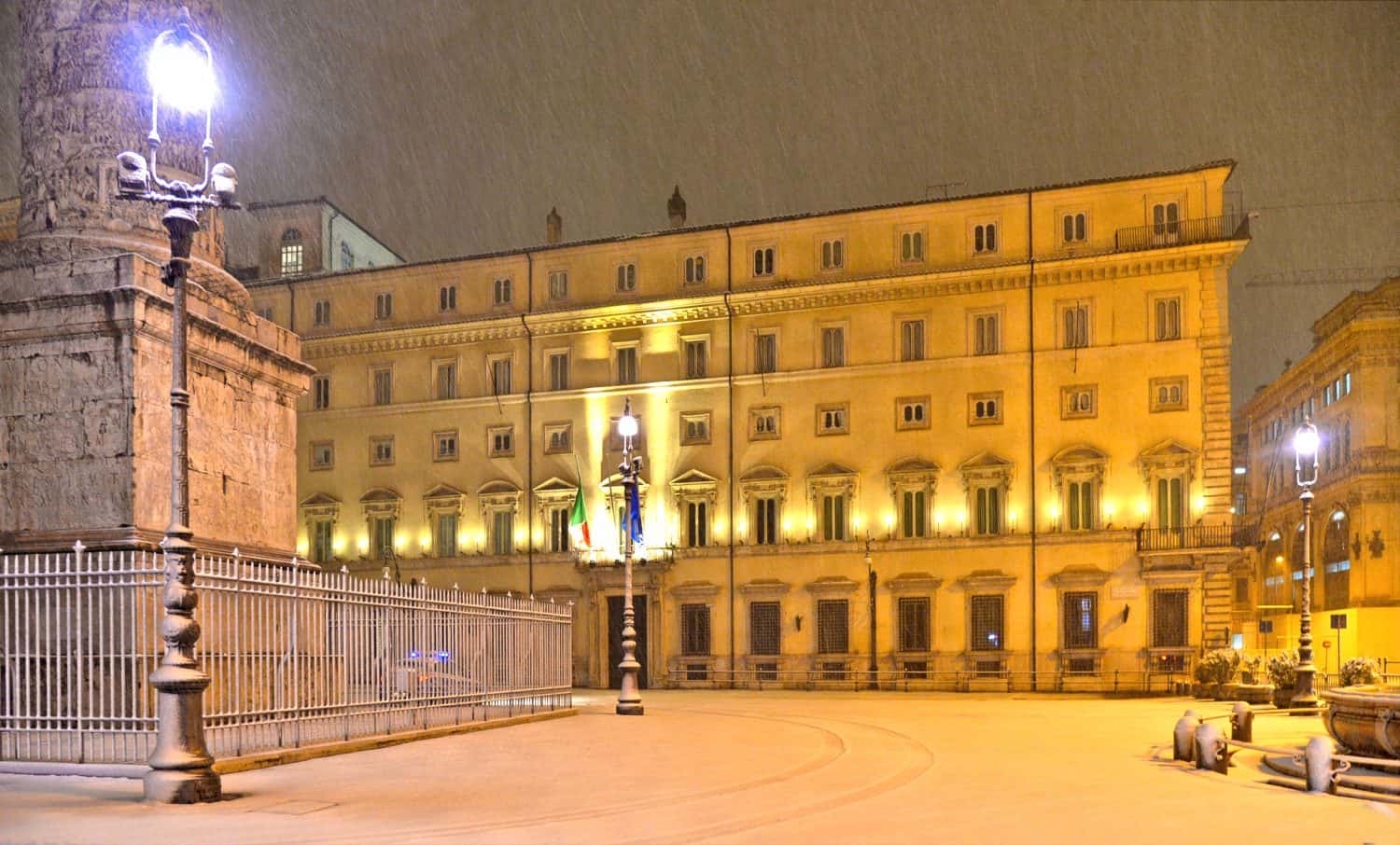 Night view with heavy snowfall on square with Palazzo Chigi (Chigi Palace) home of the Italian Prime Minister located in Rome, Italy.