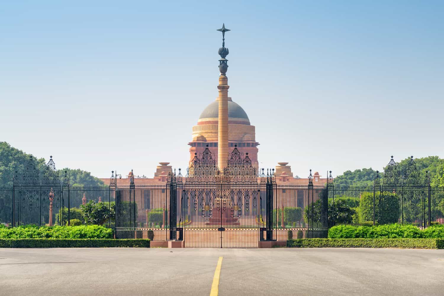 Awesome view of the main gate of Rashtrapati Bhavan and Jaipur Column in the courtyard of Presidential Residence in New Delhi, India. The official home of the President of India on blue sky background