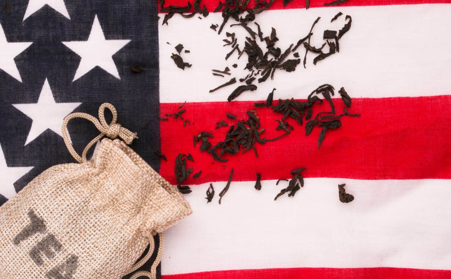 scattered tea on the American flag. Boston Tea Party, 1776 U.S. Declaration of Independence concept