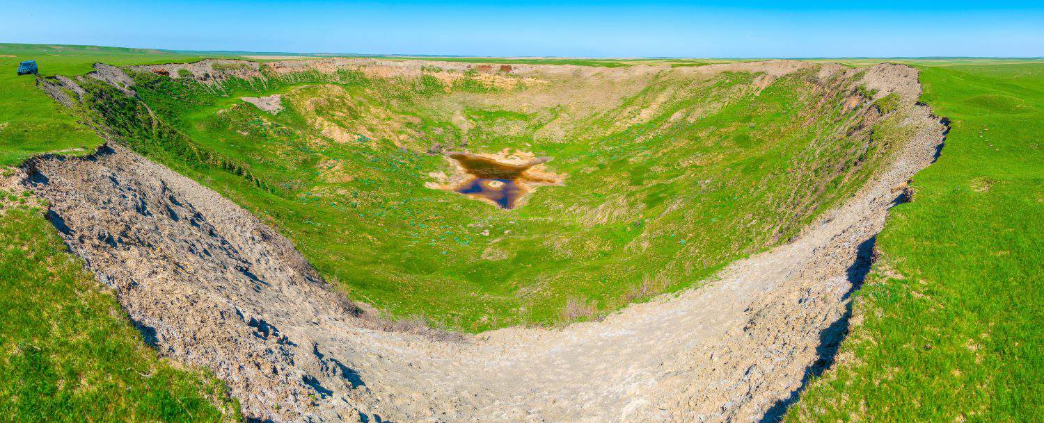 Meteorite crater Panoramic view of a meteorite crater in Kazakhstan. Crater from a nuclear test in the Soviet Union under the Meridian-2 program