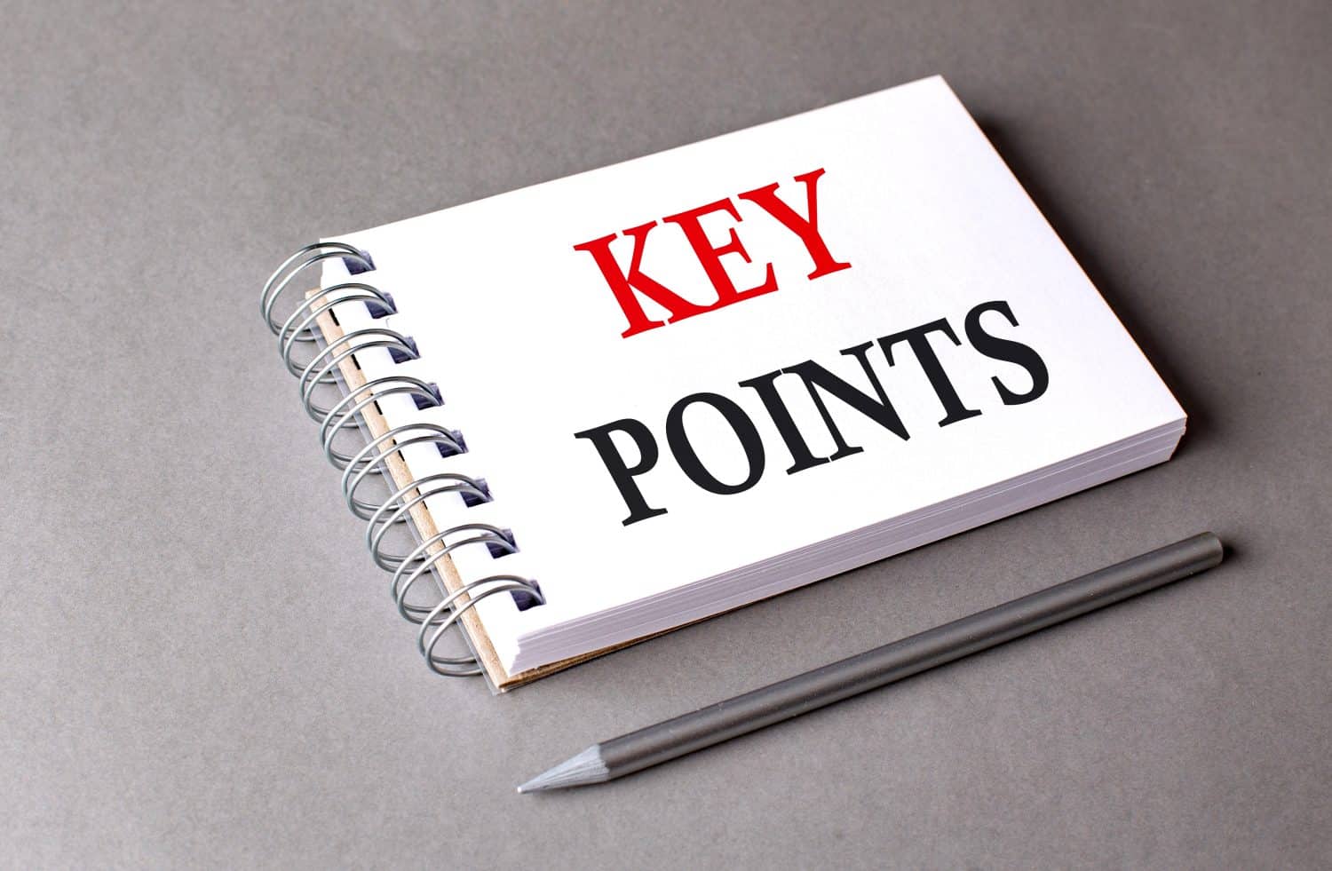 KEY POINTS word on a notebook on grey background