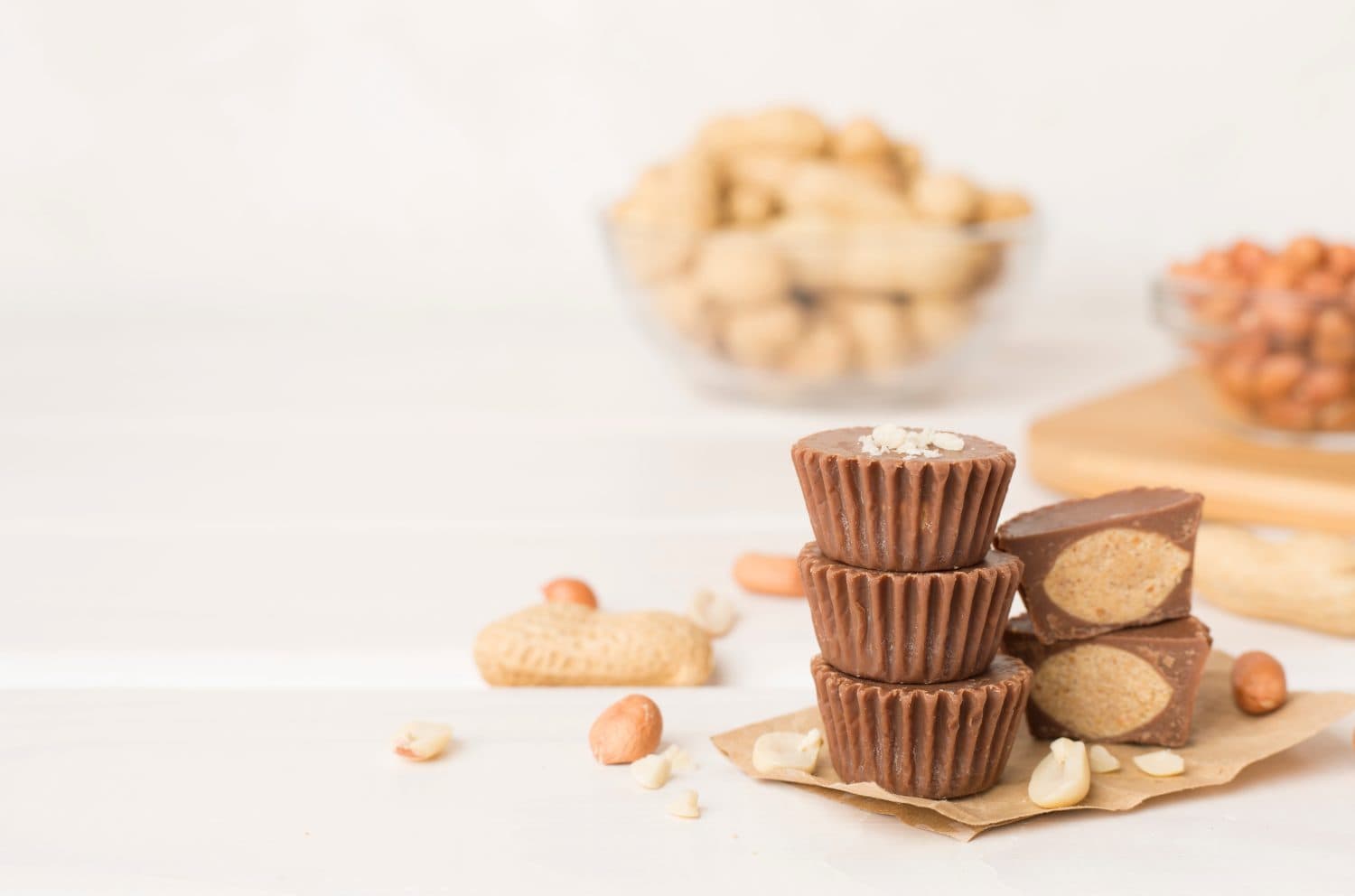 Tasty chocolate peanut butter cups on wooden table