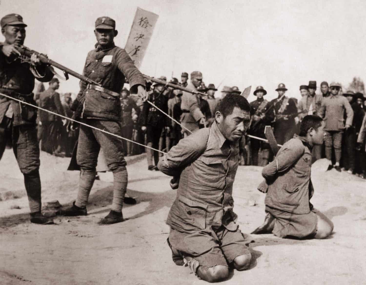 Two Chinese men kneeling prior to execution by Chinese soldiers. The Sino-Japanese war (1937-1945) Fight against the Japanese occupation as well as a civil war between the Nationalists and Communists.