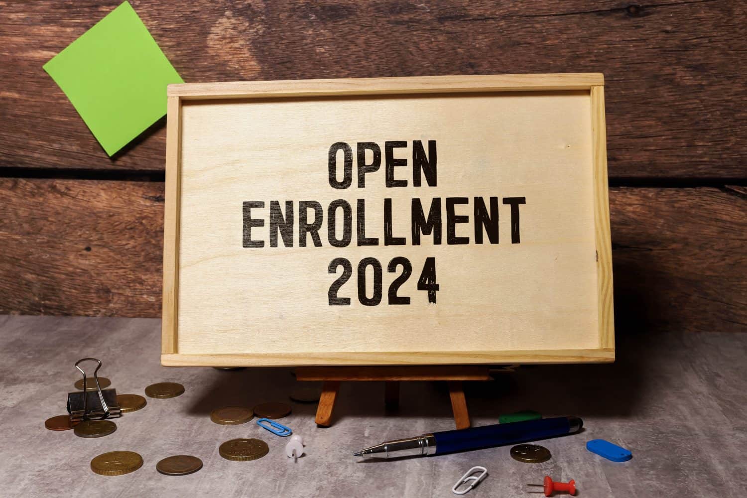 Concept of Open Enrollment 2024 write on sticky notes isolated on Wooden Table.