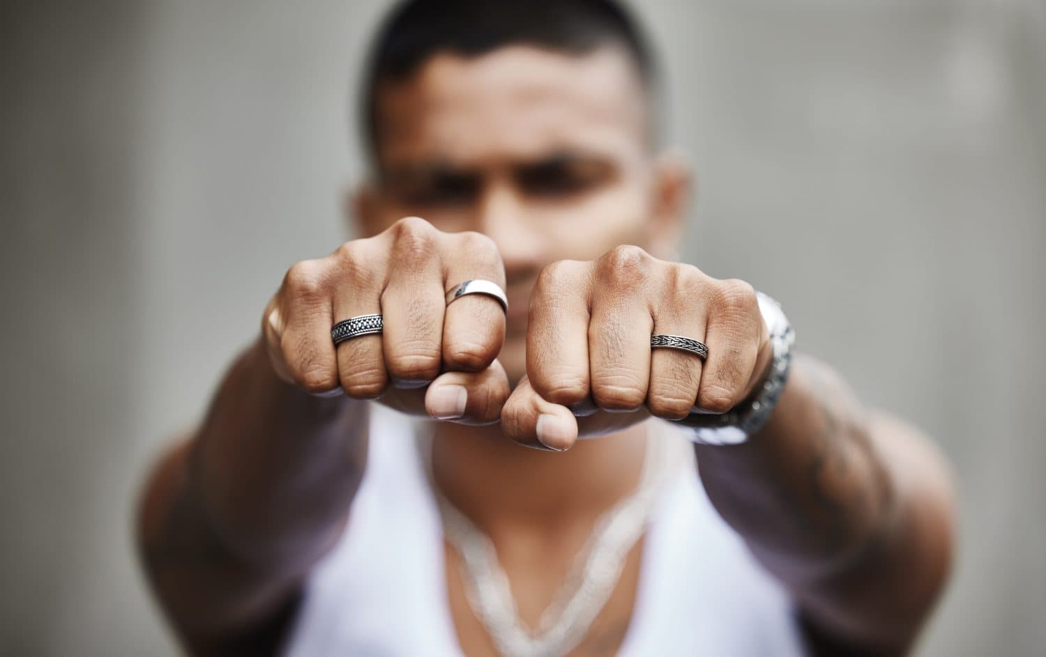 Hands, ring and man with fashion, jewellery and gangster with style, accessories and fist. Person, hand gesture and guy with trendy outfit, wearable and elegant with confidence, silver and luxury