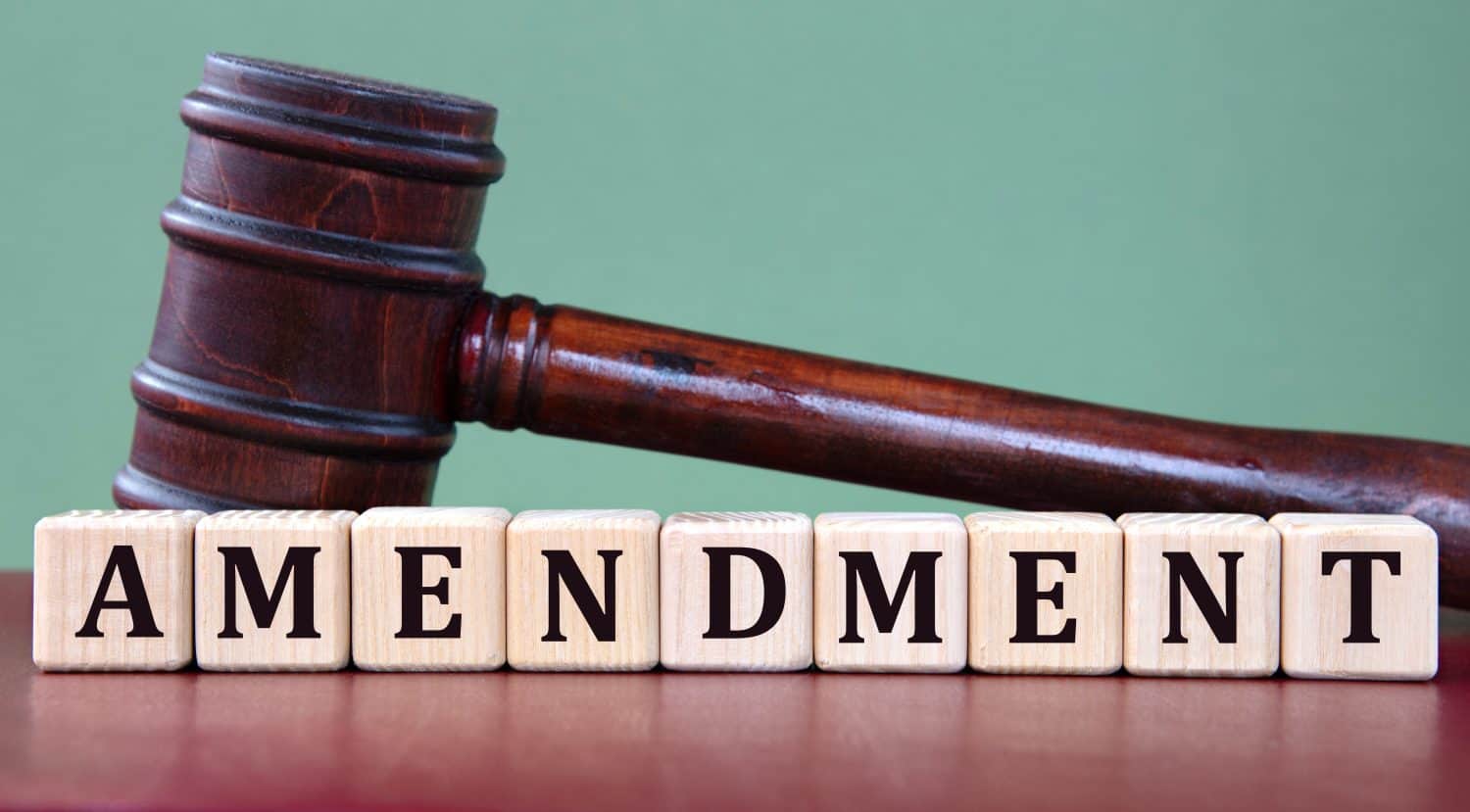 AMENDMENT - word on wooden cubes on background of judge&#039;s gavel. Info concept