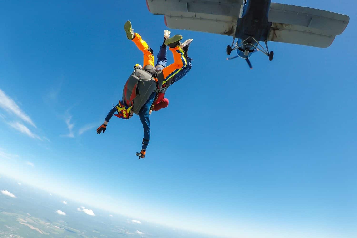 Skydiving tandem jumping out of a plane