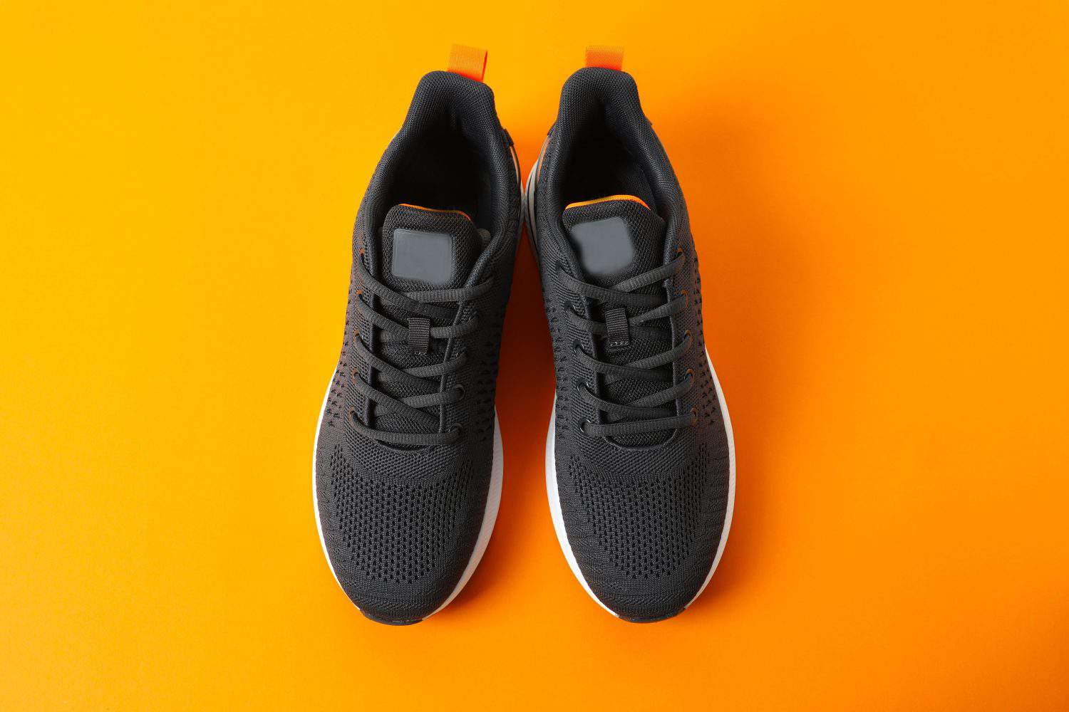 Pair of stylish sneakers on a color background