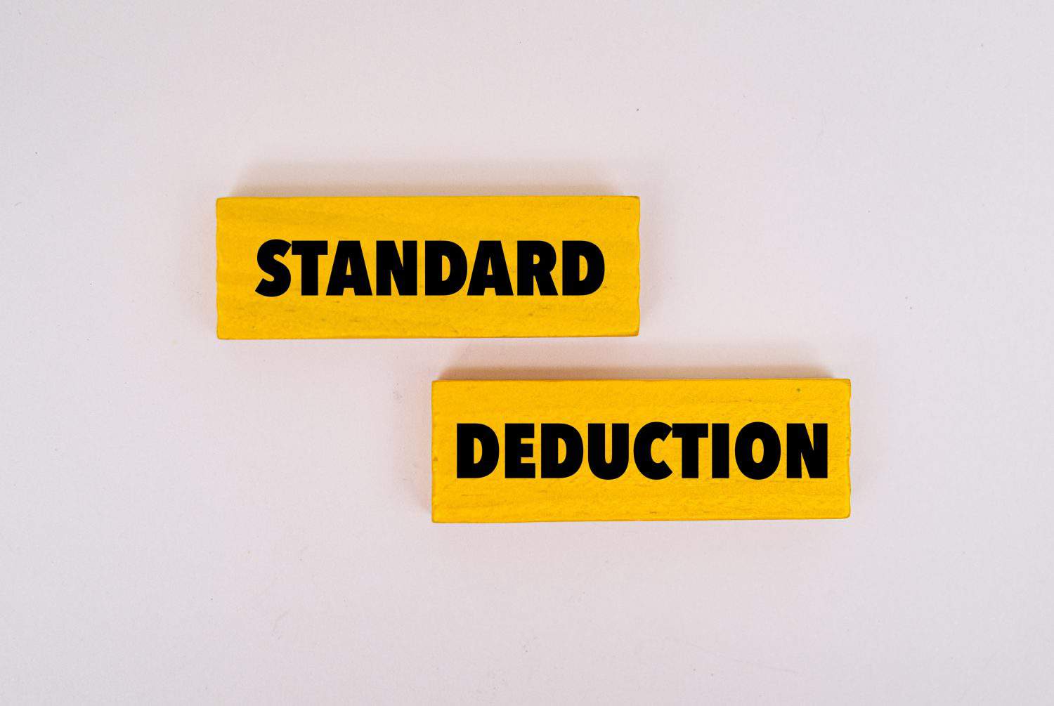 A coloured wooden block with text STANDARD DEDUCTION on it