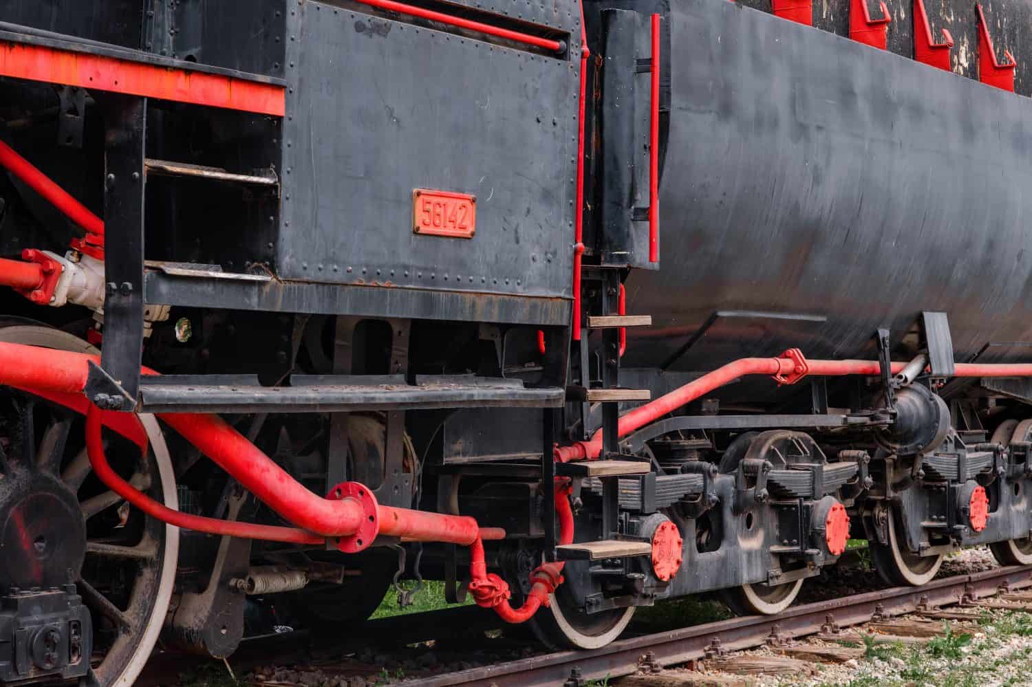 Old steam train on the tracks. Full frame photo. Transportation from historical times. The steam engine industrial revolution.