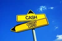 Cash or Credit card - Traffic sign with two options - financial dilemma of paying with banknotes and physical money vs making payment by using modern plastic electronic cards