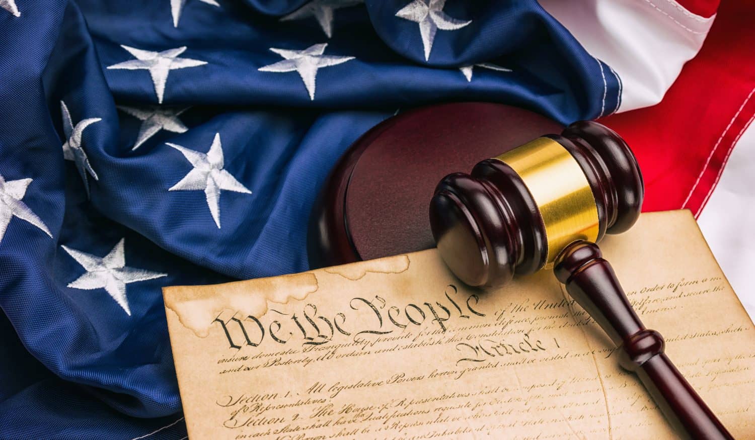 American Constitution - We the people with USA Flag and judge gavel