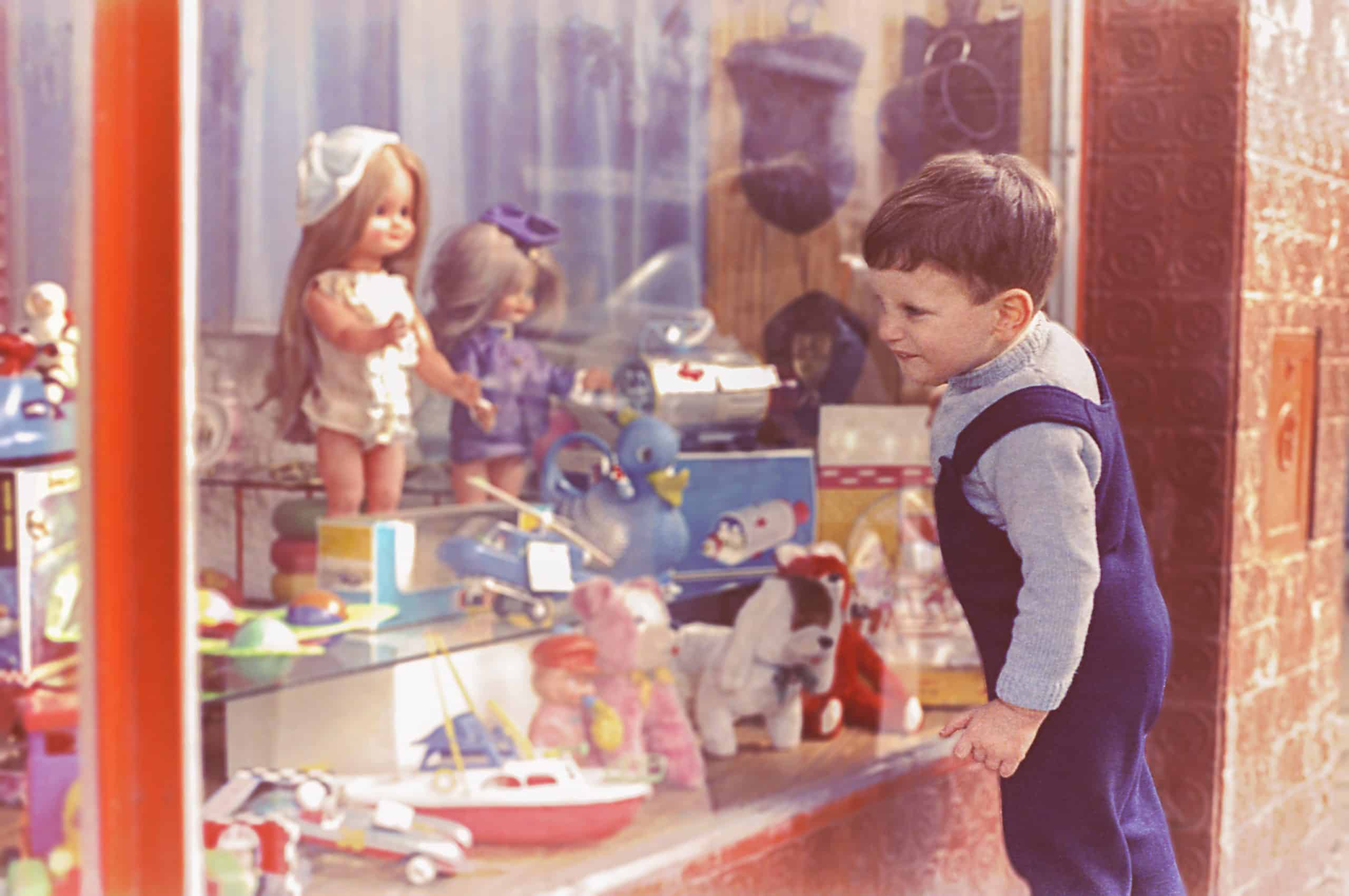 Vintage kid looking at a toy's shop