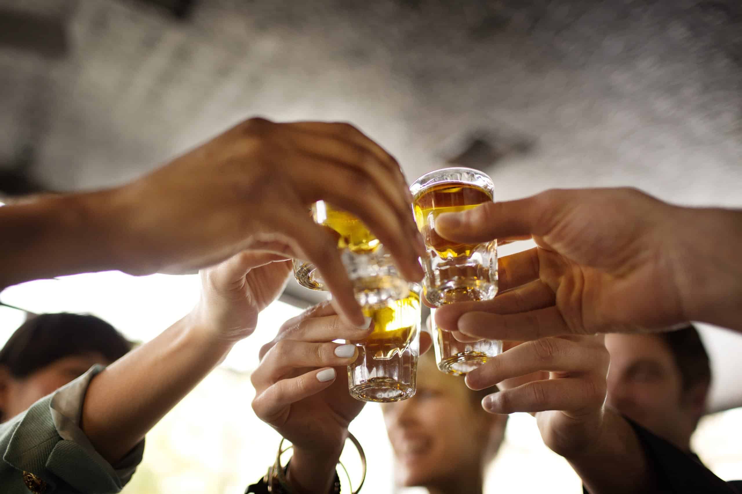 Friends enjoying tequila in bar