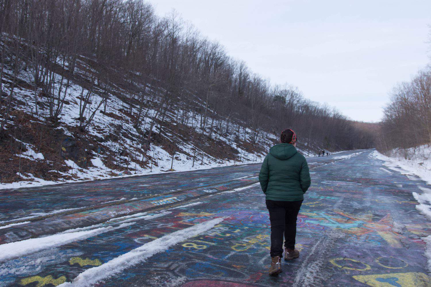 A young woman walking down Centralia&#039;s abandoned graffiti highway.