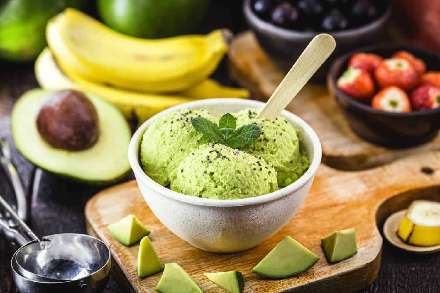 natural avocado ice cream, without preservatives, with tropical fruits from brazil in the background.