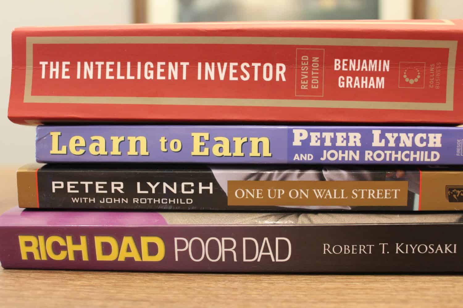 A stack of four books on investing, for beginners.