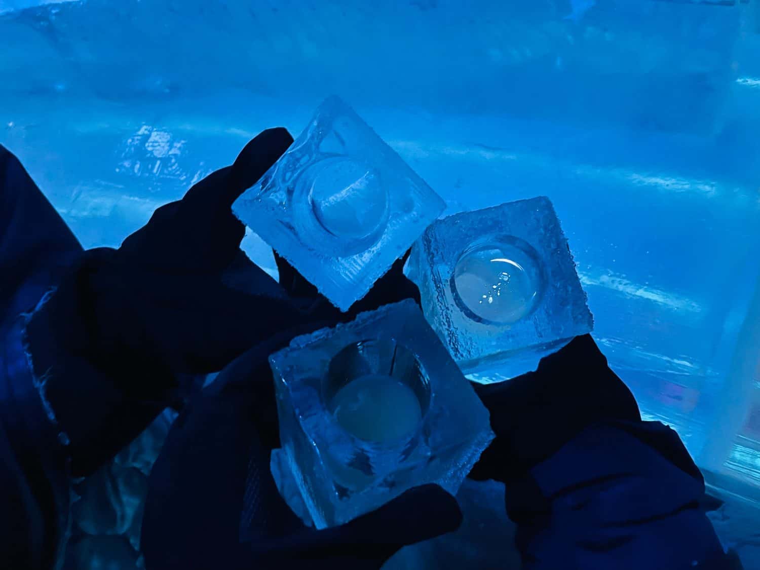 top view of drink in glass made of ice in ice bar with other ice glasses in background. View from Famous Ice bar in Stockholm Sweden.