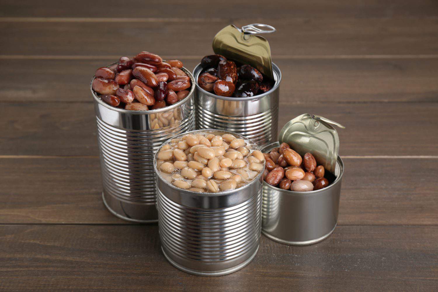 Tin cans with kidney beans on wooden table