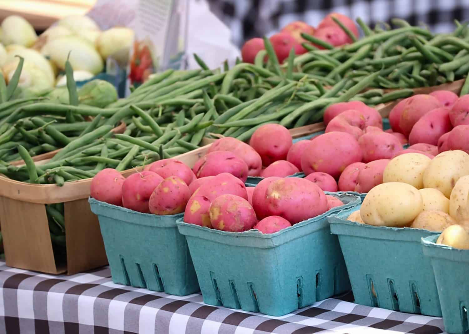 Fresh Potatoes and Green Beans Set Out at Farmer&#039;s Market.