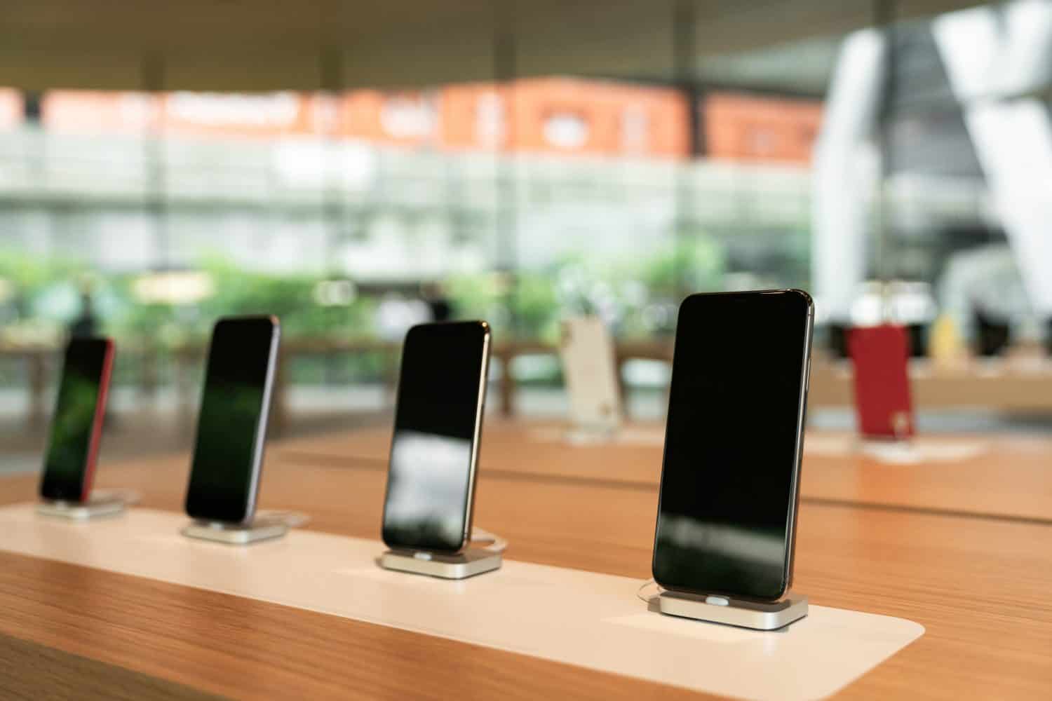 Smartphones on the shelf of the technology store. Department of mobile phones in the tech store. Technology concept.