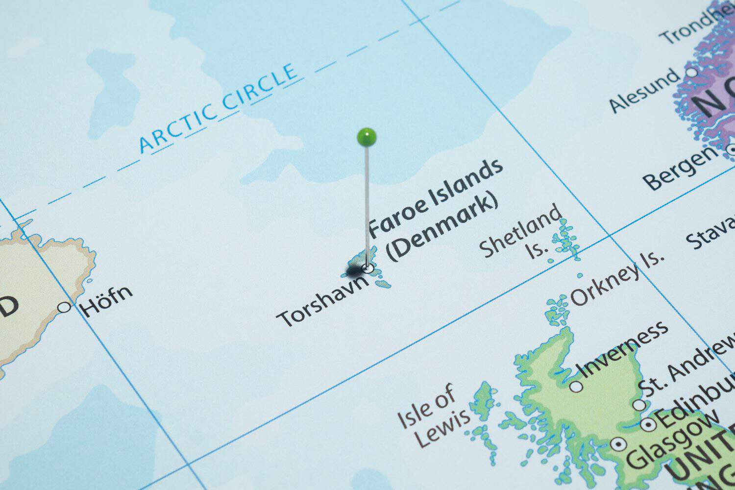 Close up to a Torshavn city with a green pin needle into Faroe Islands country political map