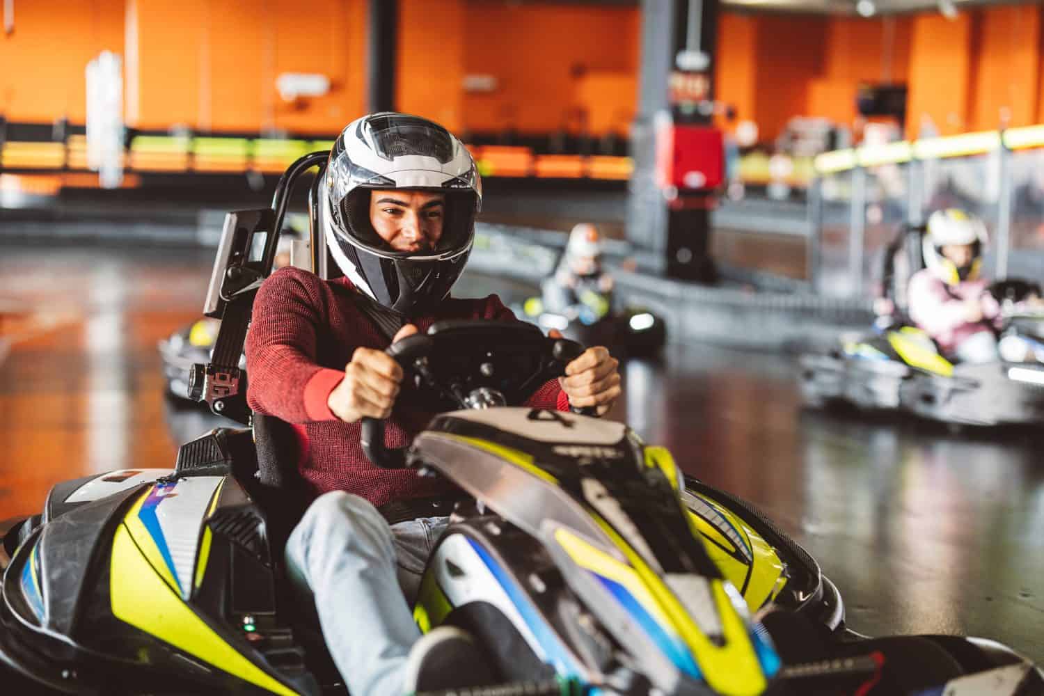 Young Man Leading a Group in Indoor Go-Kart Race