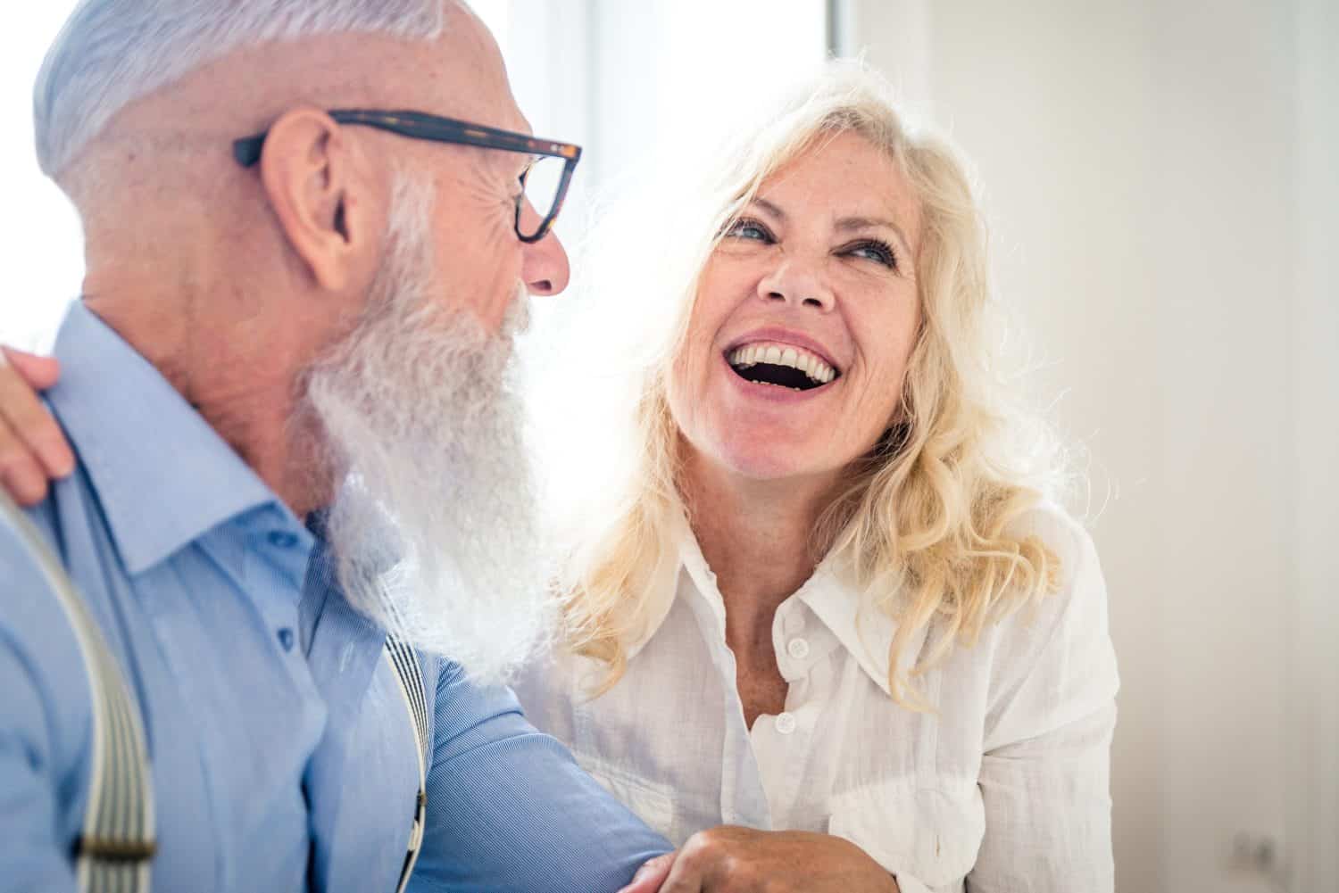 Happy senior couple having breakfast at home - Married couple on the 60's in their apartment, concepts about senority and relationship