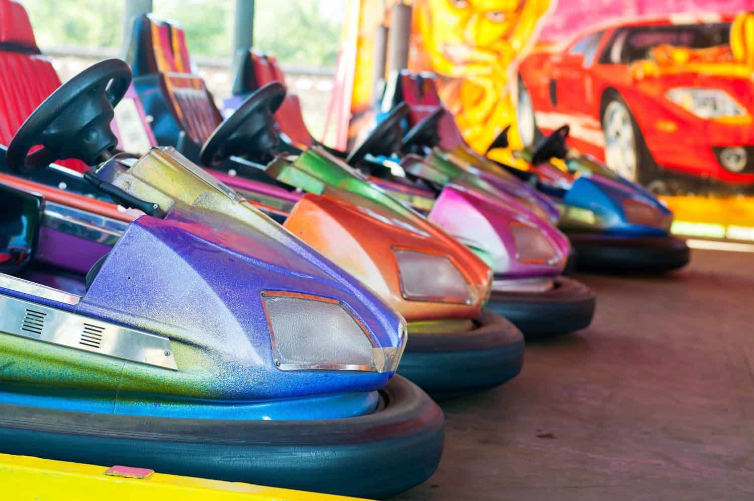 Colorful electric bumper car in autodrom in the fairground attractions at amusement park. Selective focus on the cars